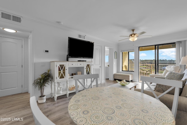 663 William Hilton Pkwy # 2309, Hilton Head Island, SC 29928 - dining room with crown molding, light wood finished floors, visible vents, and ceiling fan