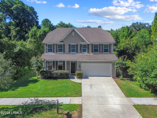 view of front of house featuring a garage and a front lawn