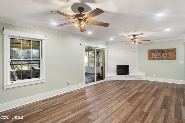 unfurnished living room with ornamental molding, dark wood-style flooring, a fireplace, and baseboards