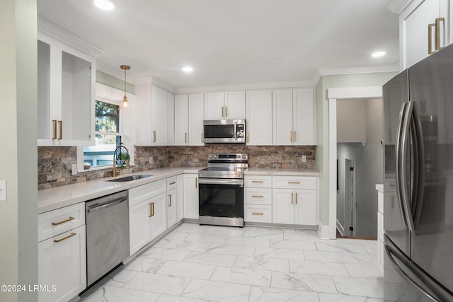 kitchen featuring decorative light fixtures, marble finish floor, light countertops, stainless steel appliances, and a sink