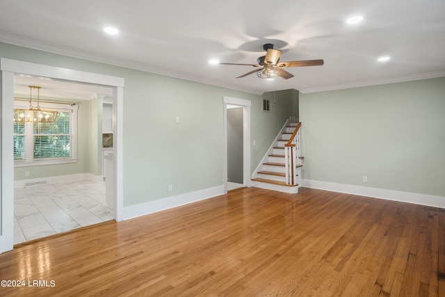 empty room featuring stairs, baseboards, visible vents, and crown molding