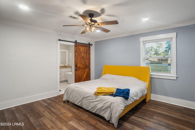 bedroom with dark wood-style flooring, crown molding, baseboards, and a barn door