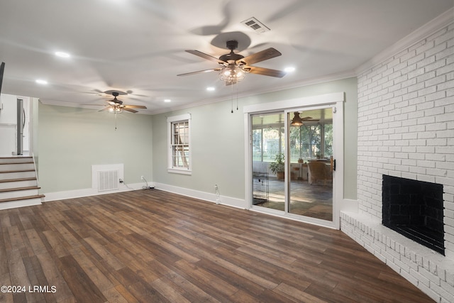 unfurnished living room with ornamental molding, dark wood-type flooring, a fireplace, and visible vents