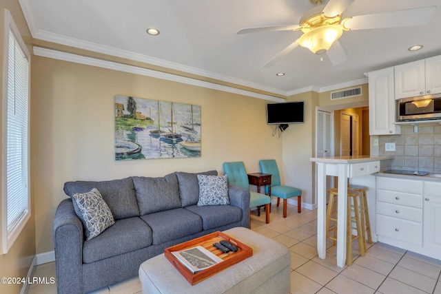 tiled living room featuring ornamental molding and ceiling fan