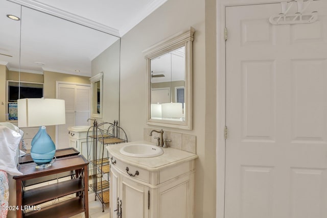 bathroom with ornamental molding and vanity