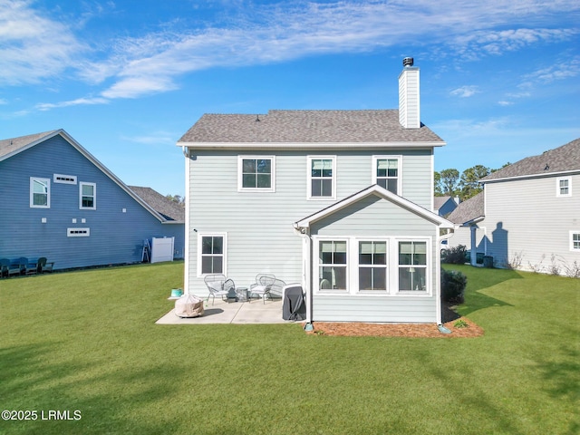 back of property featuring a lawn and a patio