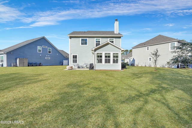 back of house with a yard and a patio