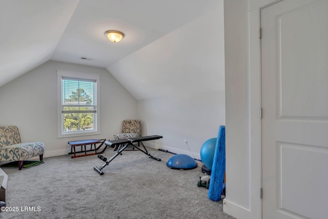 workout room featuring vaulted ceiling and carpet