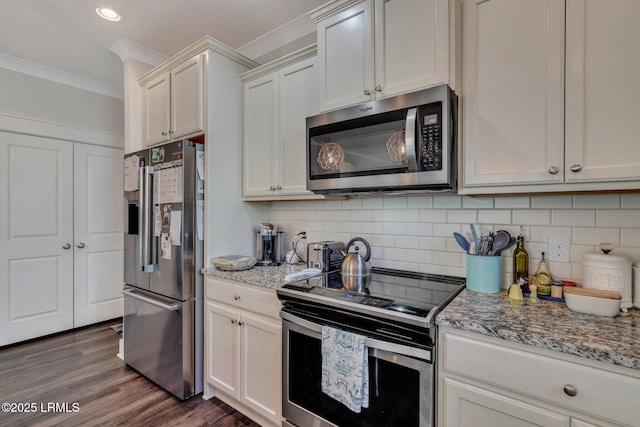 kitchen with crown molding, stainless steel appliances, light stone counters, dark hardwood / wood-style flooring, and decorative backsplash