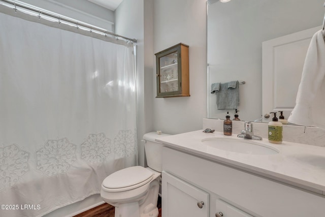 full bathroom featuring shower / tub combo with curtain, vanity, toilet, and hardwood / wood-style floors