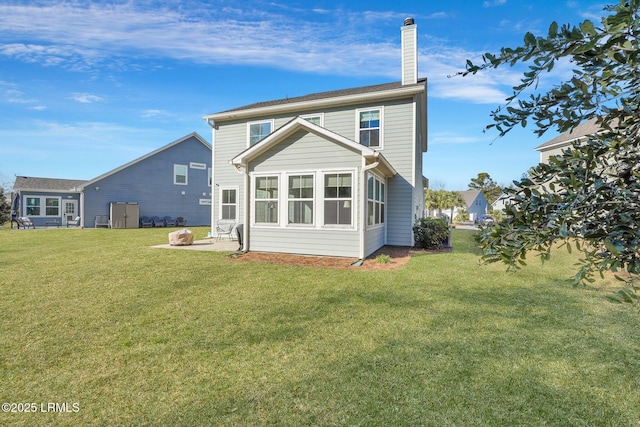 back of property featuring a patio and a yard