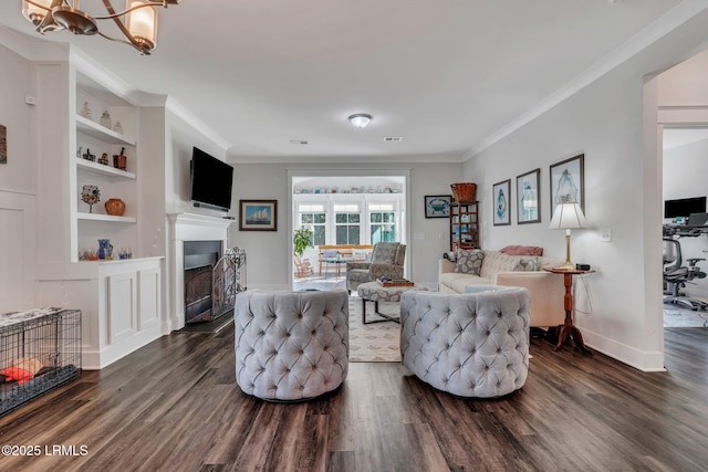 living room with ornamental molding, dark hardwood / wood-style floors, and built in features