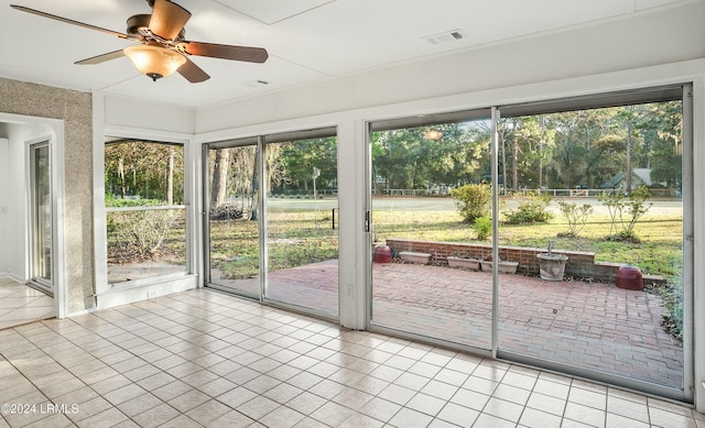 unfurnished sunroom featuring plenty of natural light and ceiling fan