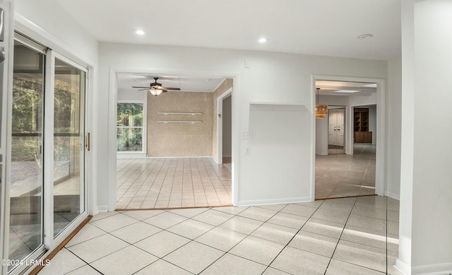 interior space featuring ceiling fan and light tile patterned floors