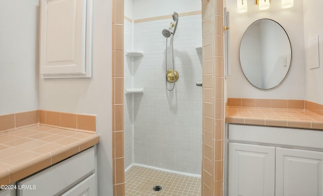 bathroom with vanity and tiled shower