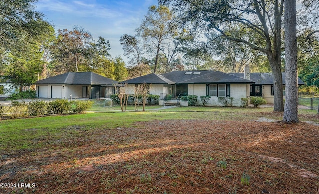 view of front of house with a garage and a front lawn