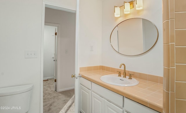 bathroom featuring vanity and toilet