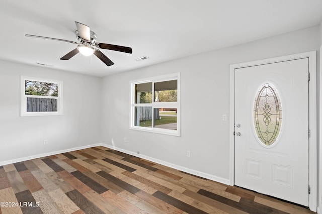 entrance foyer with dark wood-type flooring, ceiling fan, and a wealth of natural light