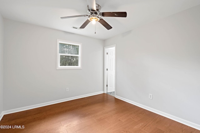 spare room featuring hardwood / wood-style flooring and ceiling fan