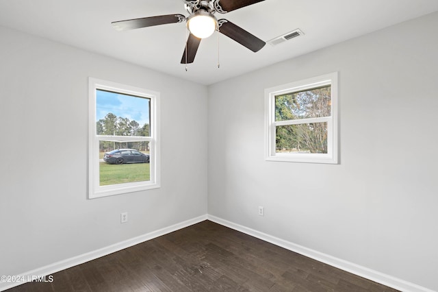 spare room with dark hardwood / wood-style floors and ceiling fan