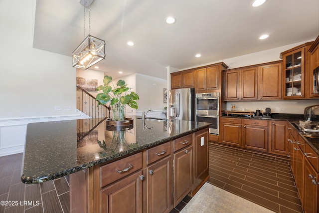 36 Independence Pl, Bluffton, SC 29910 - kitchen with appliances with stainless steel finishes, brown cabinets, a center island with sink, glass insert cabinets, and recessed lighting