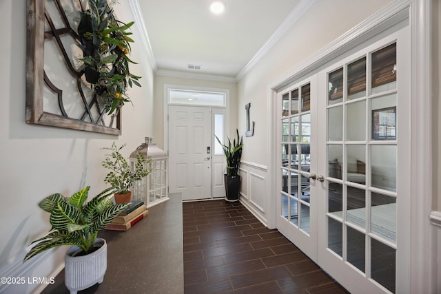 36 Independence Pl, Bluffton, SC 29910 - foyer entrance with french doors, ornamental molding, a wainscoted wall, and dark wood-type flooring