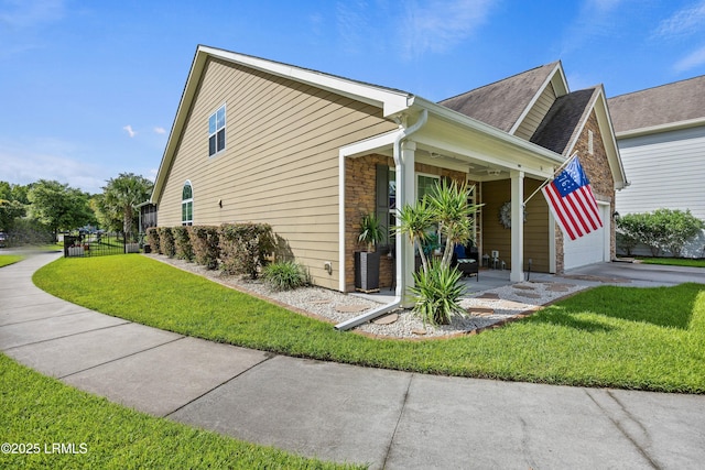 36 Independence Pl, Bluffton, SC 29910 - view of side of home featuring a lawn, concrete driveway, and roof with shingles
