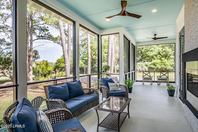 sunroom featuring ceiling fan and a healthy amount of sunlight