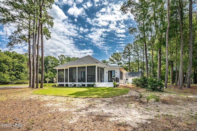 view of front facade featuring a front yard and a sunroom