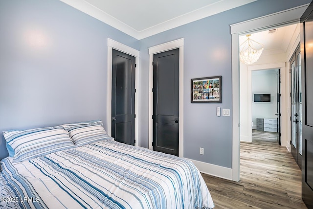 bedroom featuring an inviting chandelier and wood-type flooring