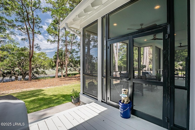 wooden deck with a sunroom and a yard