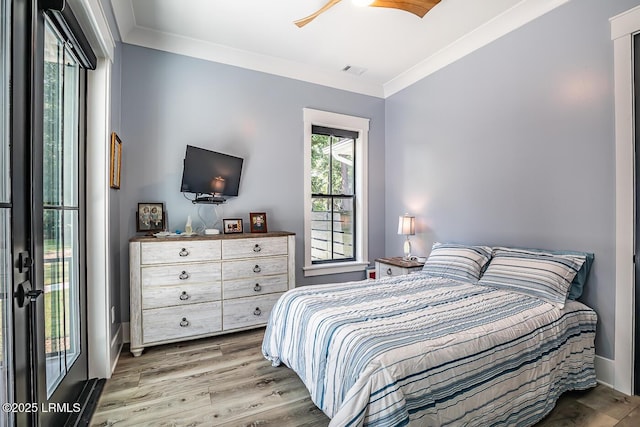 bedroom with crown molding, hardwood / wood-style flooring, and ceiling fan