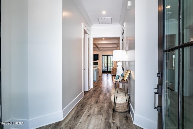 hallway featuring coffered ceiling, hardwood / wood-style flooring, and beamed ceiling