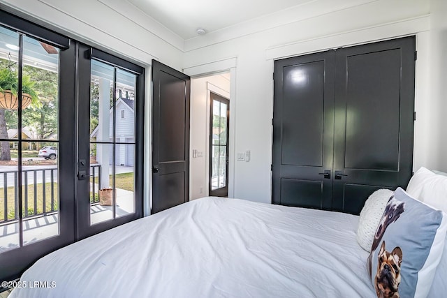 bedroom featuring multiple windows, access to outside, and french doors