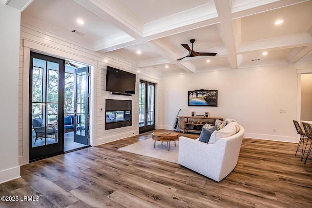 living room with beamed ceiling, wood-type flooring, and coffered ceiling