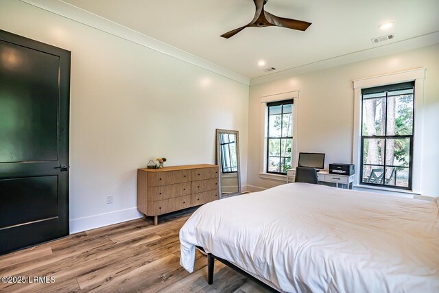 bedroom with multiple windows, crown molding, hardwood / wood-style floors, and ceiling fan