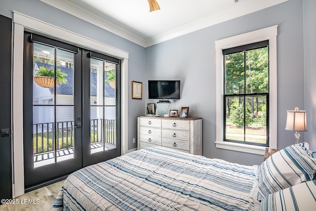 bedroom with french doors, ornamental molding, light hardwood / wood-style floors, and access to outside