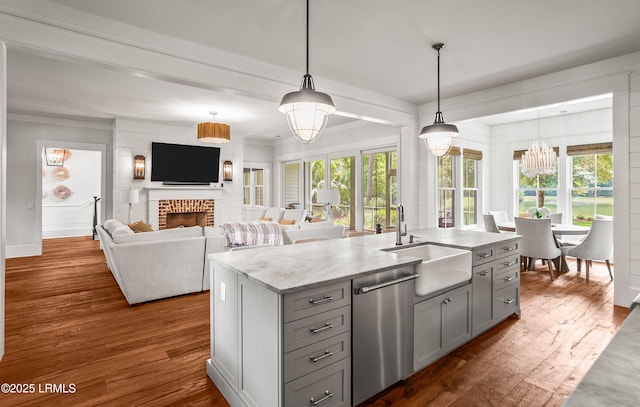 575 Distant Island Dr, Beaufort, SC 29907 - kitchen featuring stainless steel dishwasher, gray cabinets, a brick fireplace, a chandelier, and dark wood-style floors