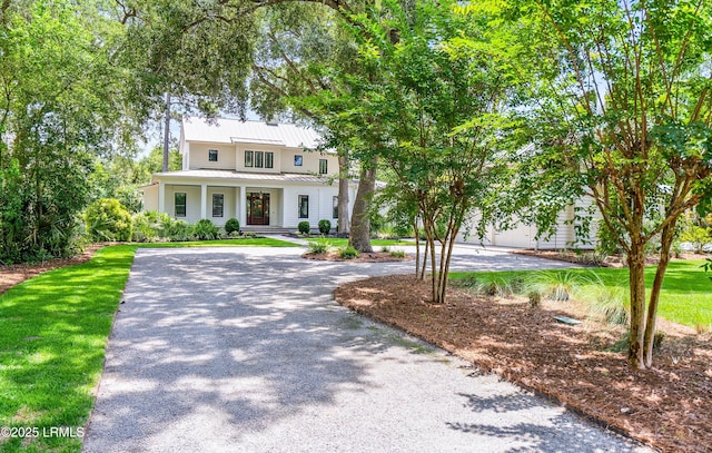 575 Distant Island Dr, Beaufort, SC 29907 - view of front of home featuring curved driveway, covered porch, a metal roof, and a standing seam roof