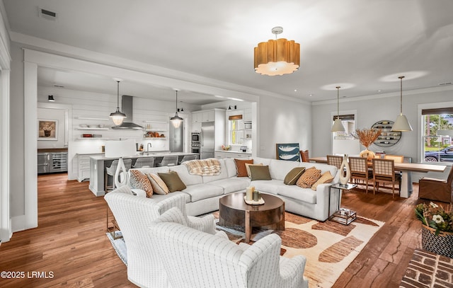 575 Distant Island Dr, Beaufort, SC 29907 - living room featuring light wood-type flooring, beverage cooler, and crown molding