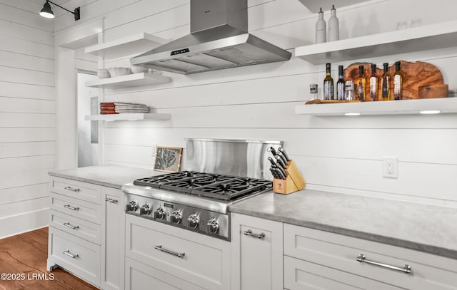 575 Distant Island Dr, Beaufort, SC 29907 - kitchen with open shelves, wall chimney exhaust hood, stainless steel gas stovetop, wood finished floors, and white cabinets
