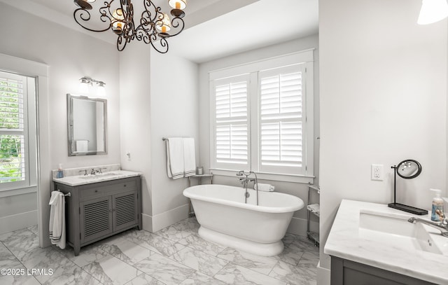 575 Distant Island Dr, Beaufort, SC 29907 - bathroom featuring marble look tiles, vanity, a freestanding tub, and a chandelier