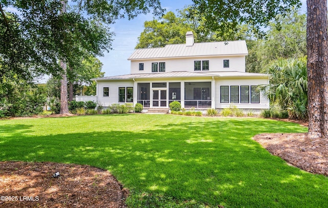 575 Distant Island Dr, Beaufort, SC 29907 - back of house featuring a sunroom, a chimney, a yard, and a standing seam roof