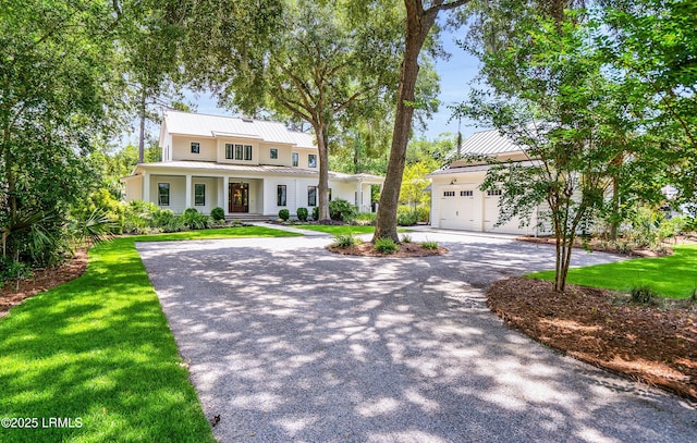 575 Distant Island Dr, Beaufort, SC 29907 - view of front of house with a standing seam roof, driveway, covered porch, and a metal roof