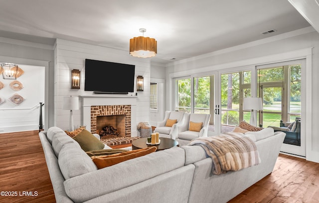 575 Distant Island Dr, Beaufort, SC 29907 - living room featuring wood finished floors, a brick fireplace, and french doors