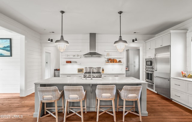 575 Distant Island Dr, Beaufort, SC 29907 - kitchen with appliances with stainless steel finishes, open shelves, wall chimney range hood, a warming drawer, and a breakfast bar area