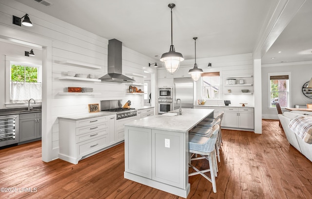 575 Distant Island Dr, Beaufort, SC 29907 - kitchen with open shelves, wall chimney range hood, appliances with stainless steel finishes, wine cooler, and ornamental molding