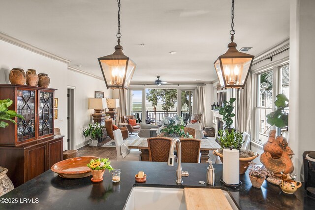 15 Sunset Blvd Unit 1201, Beaufort, SC 29907 - dining room featuring a chandelier, healthy amount of natural light, a ceiling fan, ornamental molding, and wood finished floors