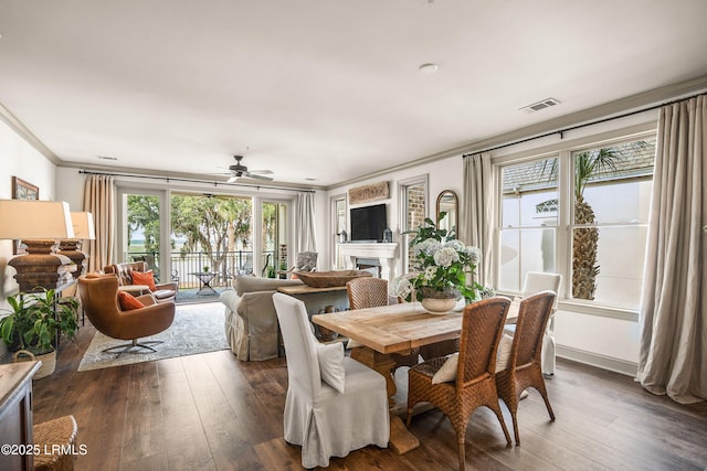 15 Sunset Blvd Unit 1201, Beaufort, SC 29907 - dining area with crown molding, a fireplace, a ceiling fan, and dark wood finished floors