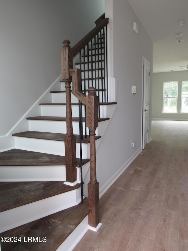 stairs featuring wood-type flooring